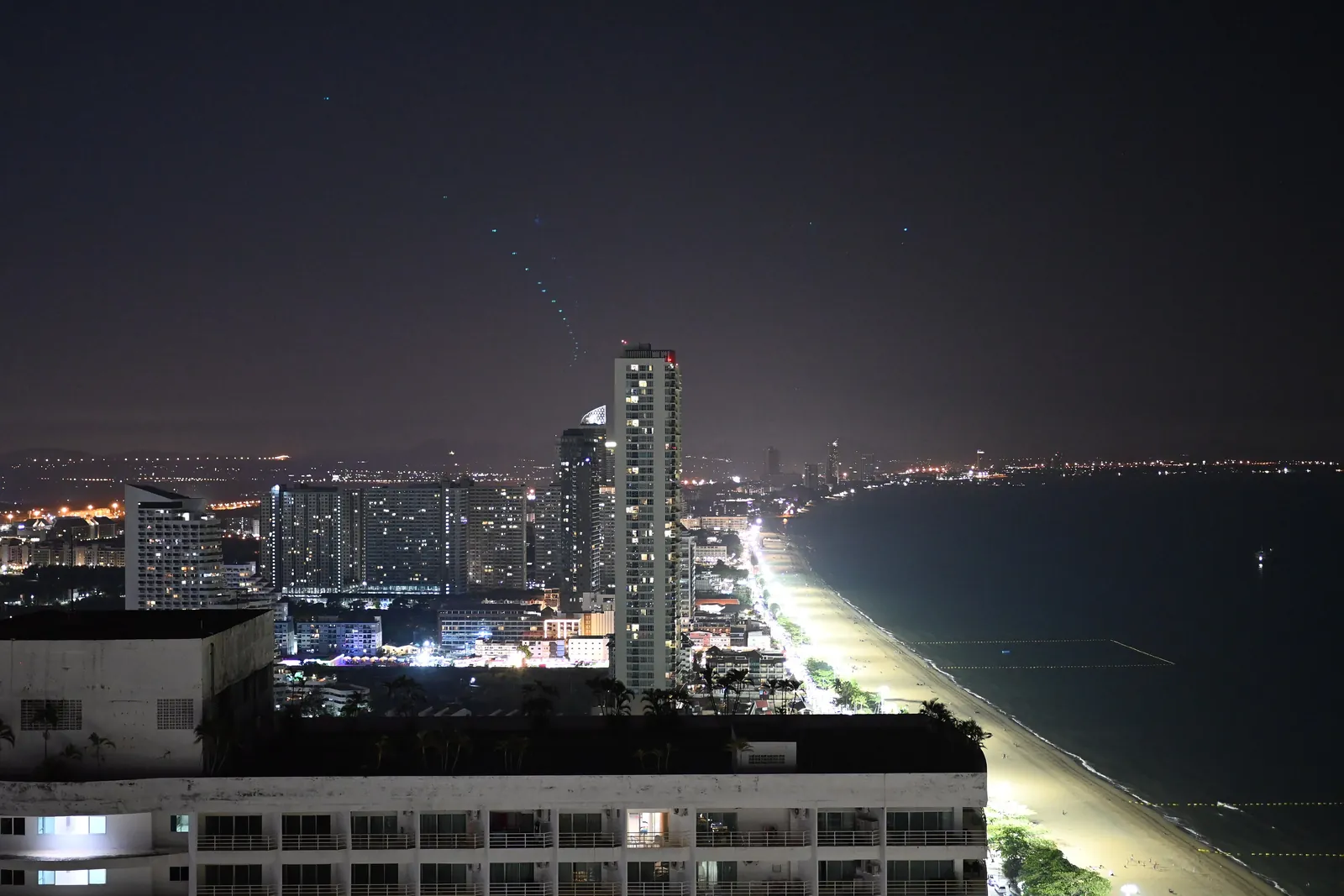 Pattaya skyline and beach road lit up at night