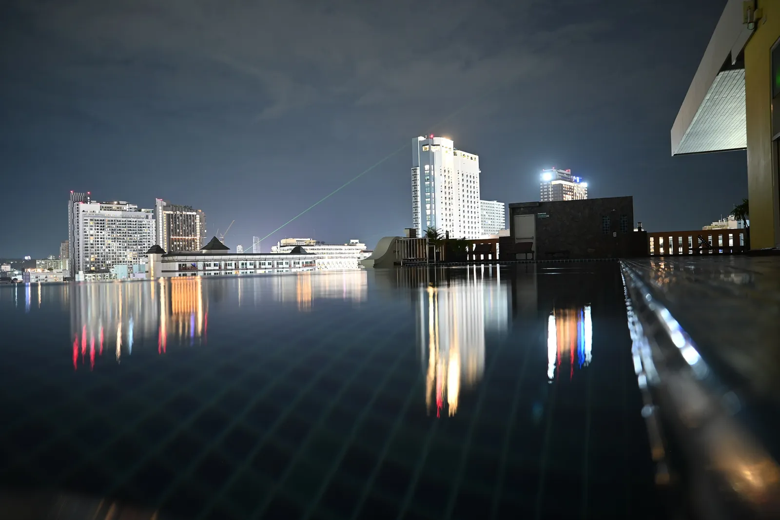 Rooftop infinity pool with Pattaya city lights at night