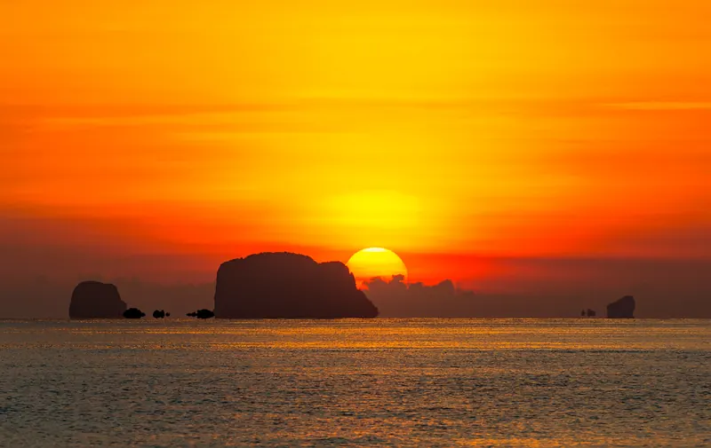 Sunset over limestone islands seen from a yacht